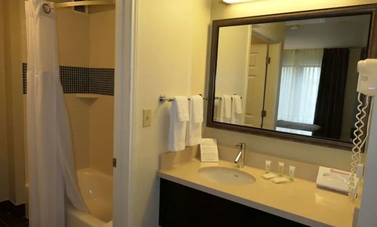 Private guest bathroom with combined shower and tub at Sonesta ES Suites Portland Vancouver 41st Street.