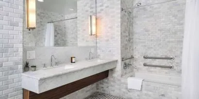 Private guest bathroom with combined shower and tub at Nautilus Sonesta Miami Beach.