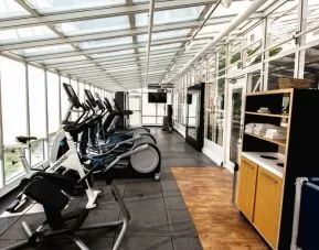 Fitness center with natural light at Embassy Suites By Hilton San Francisco Airport Waterfront.