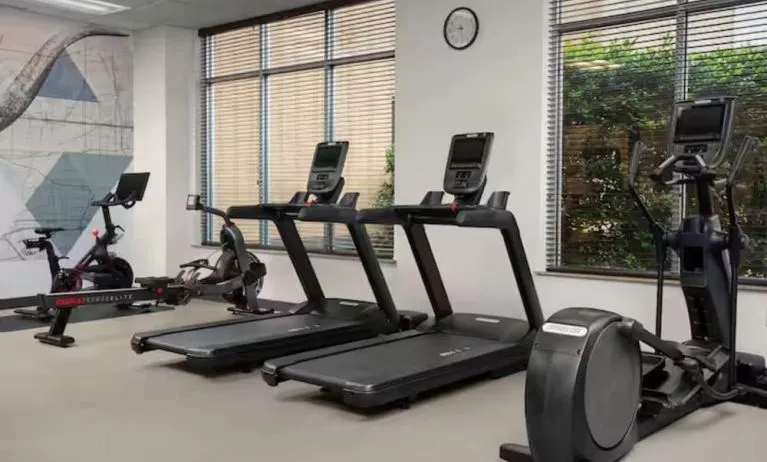 Fitness center with natural light at Hilton Garden Inn Fort Worth Medical Center.