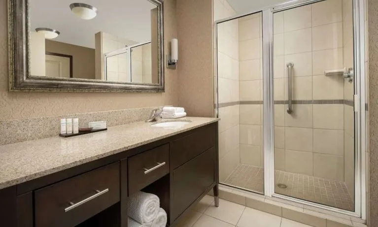 Guest bathroom with shower at Embassy Suites By Hilton Birmingham.