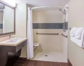 Accessible private guest bathroom with shower at Sonesta ES Suites Atlanta - Perimeter Center.