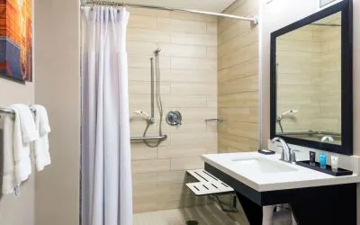Accessible private guest bathroom with shower at Sonesta Atlanta Airport North.