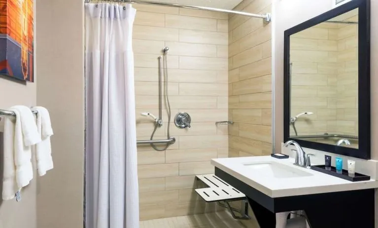 Accessible private guest bathroom with shower at Sonesta Atlanta Airport North.