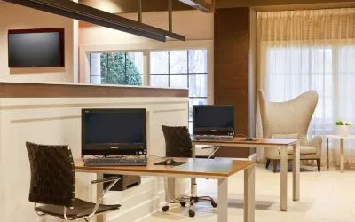 Business center with computers, printer and comfortable seating at Sonesta Atlanta Airport South.
