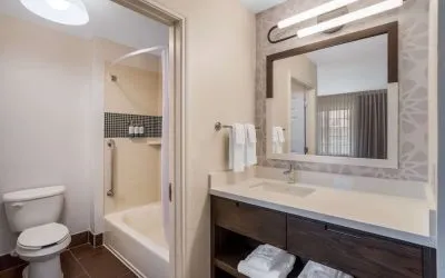 Private guest bathroom with combined shower and tub at Sonesta ES Suites Denver South - Park Meadows.