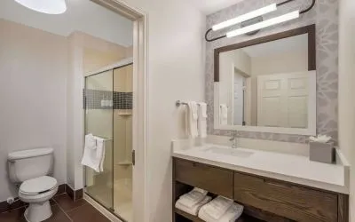 Private guest bathroom with shower and free toiletries at Sonesta ES Suites Denver South - Park Meadows.