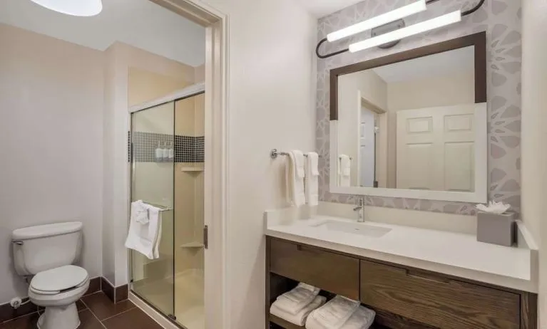 Private guest bathroom with shower and free toiletries at Sonesta ES Suites Denver South - Park Meadows.
