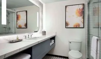 Private guest bathroom with shower and free toiletries at Sonesta Los Angeles Airport LAX.