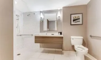 Private guest bathroom with shower and free toiletries at Sonesta Anaheim Resort Area.