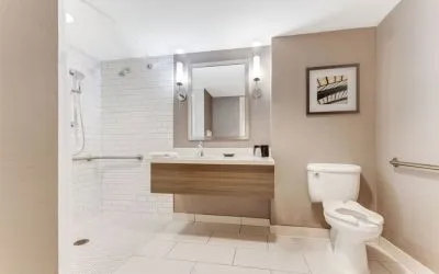 Private guest bathroom with shower and free toiletries at Sonesta Anaheim Resort Area.