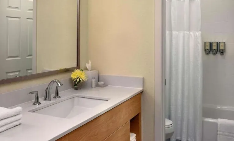 Private guest bathroom with combined shower and tub at Sonesta ES Suites Flagstaff.