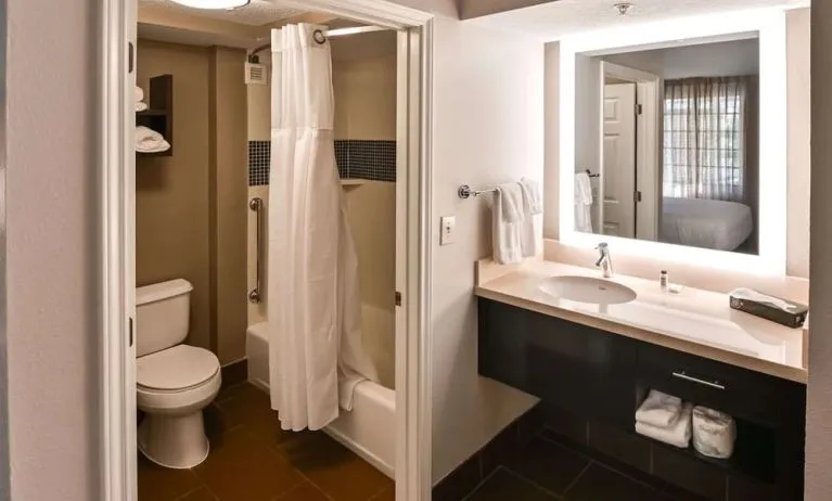 Private guest bathroom with combined shower and tub at Sonesta ES Suites San Antonio Northwest - Medical Center.