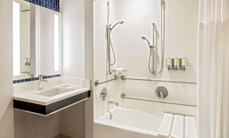 Private guest bathroom with combined shower and tub at Royal Sonesta Boston.