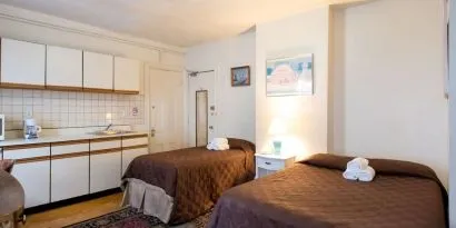 Day use twin room with in-room kitchen and work desk at The Farrington Inn.