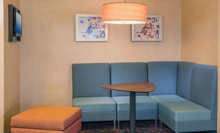 Lobby workspace with comfortable seating at Sonesta ES Suites Charlottesville University.