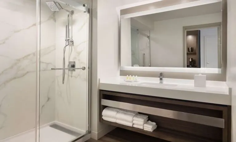 Private guest bathroom with shower and free toiletries at Royal Sonesta Kaua'i Resort Lihue.