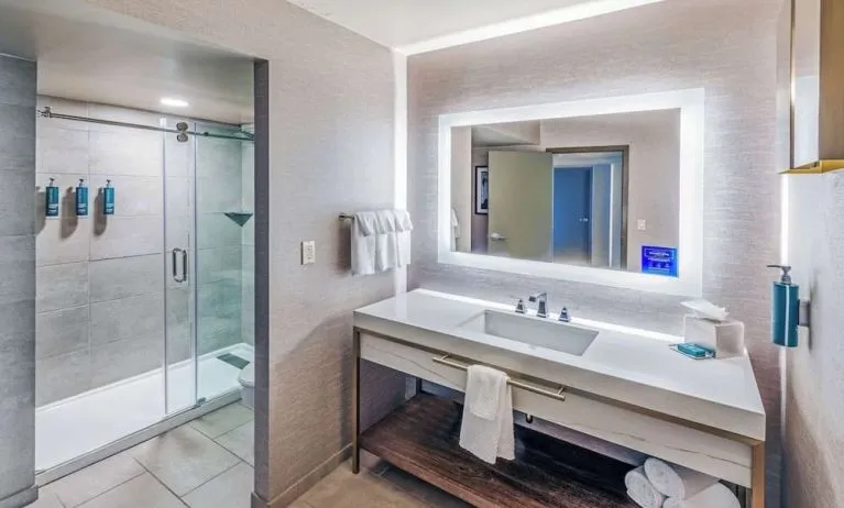 Guest bathroom with shower at DoubleTree By Hilton Tulsa-Downtown.

