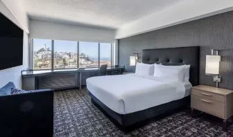Day use room with sofa and work desk overlooking the city at Hilton San Francisco Financial District.