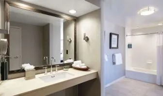 Guest bathroom with shower and tub at Hilton San Francisco Financial District.