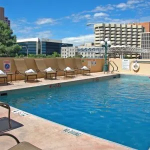 Refreshing outdoor pool surrounded by sunbeds at DoubleTree By Hilton Albuquerque.
