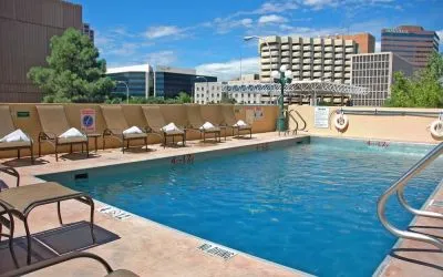 Refreshing outdoor pool surrounded by sunbeds at DoubleTree By Hilton Albuquerque.