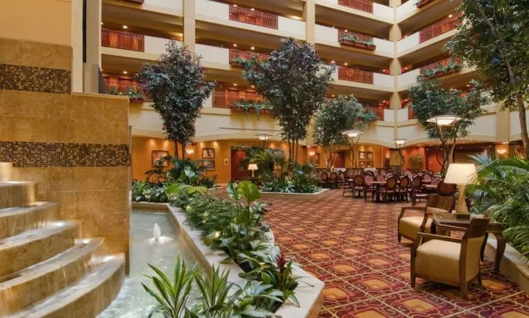 Spacious lobby and coworking lounge with natural light at Embassy Suites By Hilton Hampton Convention Center.