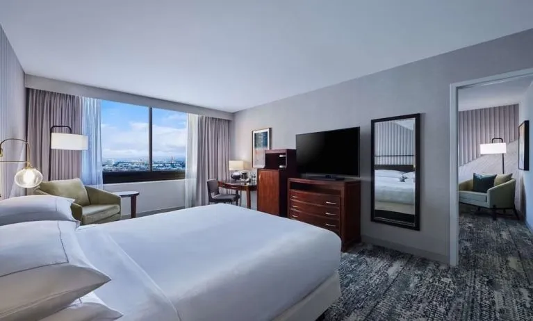 Day use room with work desk and living area at Hotel Fera Anaheim, A DoubleTree By Hilton.