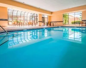 Indoor pool with lounge chairs at Sonesta Select Boston Milford.