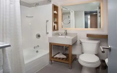 Guest bathroom with shower and tub at New York Hilton Midtown.