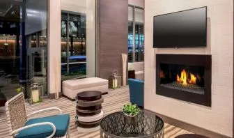 Comfortable lobby workspace by the fireplace at Hilton Garden Inn NYC Financial Center/Manhattan Downtown.
