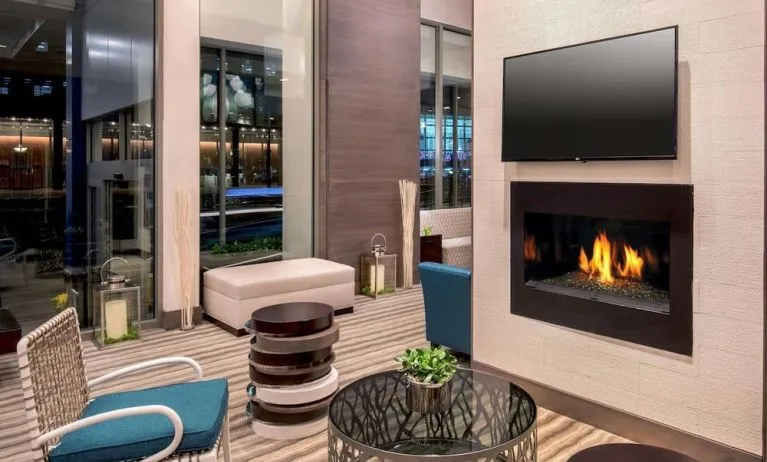 Comfortable lobby workspace by the fireplace at Hilton Garden Inn NYC Financial Center/Manhattan Downtown.
