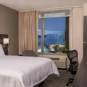 King bedroom with work station and city view at Hilton Garden Inn NYC Financial Center/Manhattan Downtown.
