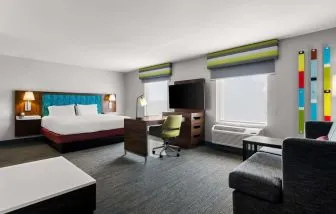 Spacious hotel suite with king size bed and working station at Hampton Inn & Suites Schererville.