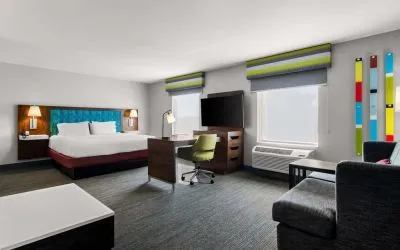 Spacious hotel suite with king size bed and working station at Hampton Inn & Suites Schererville.