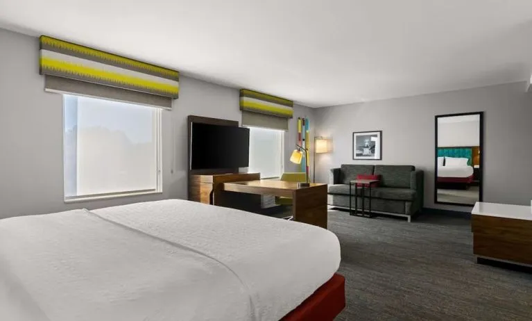 Spacious hotel suite with king size bed and working station at Hampton Inn & Suites Schererville.