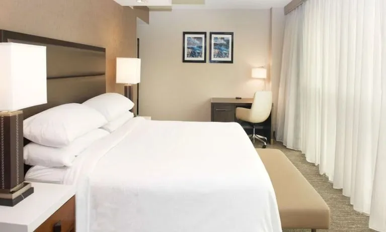 Spacious delux king room with work desk and natural light at Embassy Suites By Hilton Seattle-North-Lynnwood.