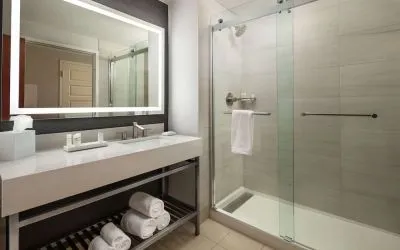 Guest bathroom with shower at Hilton Charlotte Airport.
