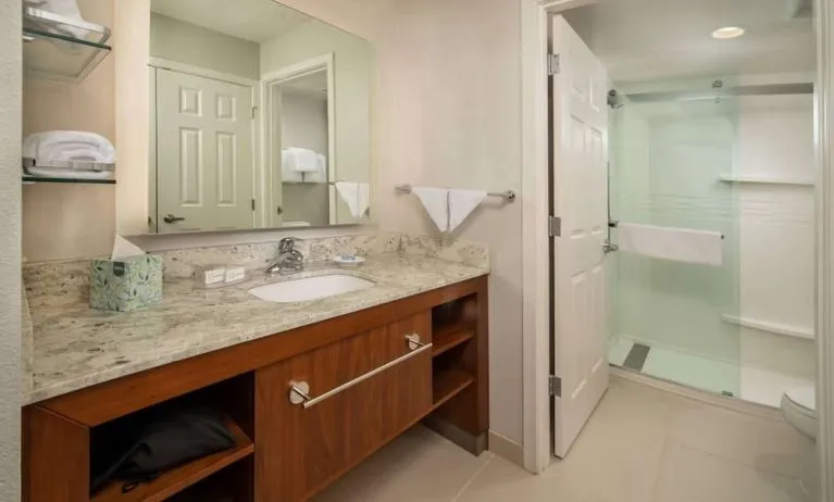 Private guest bathroom with shower and free toiletries at Sonesta ES Suites Baltimore BWI Airport.