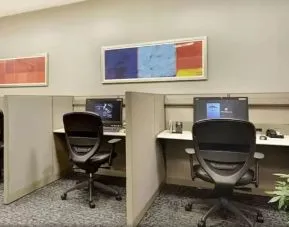 Business center with computers, printer and ergonomic chairs at New York Hilton Midtown.