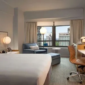 King room with work desk and sofa at New York Hilton Midtown.