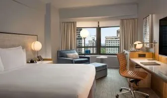 King room with work desk and sofa at New York Hilton Midtown.