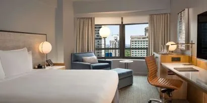 King room with work desk and sofa at New York Hilton Midtown.