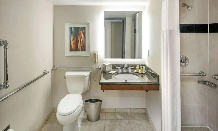 Private guest bathroom with shower and free toiletries at Hilton Minneapolis.