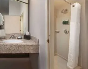 Private guest bathroom with shower and free toiletries at Sonesta Select Allentown Bethlehem Airport.