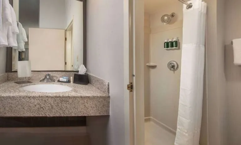 Private guest bathroom with shower and free toiletries at Sonesta Select Allentown Bethlehem Airport.