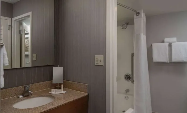 Private guest bathroom with shower and free toiletries at Sonesta Select Chattanooga Hamilton Place.