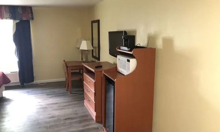 TV and mini-fridge at Quality Inn & Suites Woodstock Near Lake Geneva.