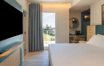 King bed with TV at Terradamari Resort & Spa Marina Di Modica.