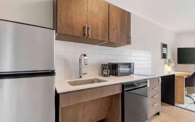 In-room kitchen with fridge, sink and microwave at Sonesta Simply Suites Baltimore BWI Airport. 